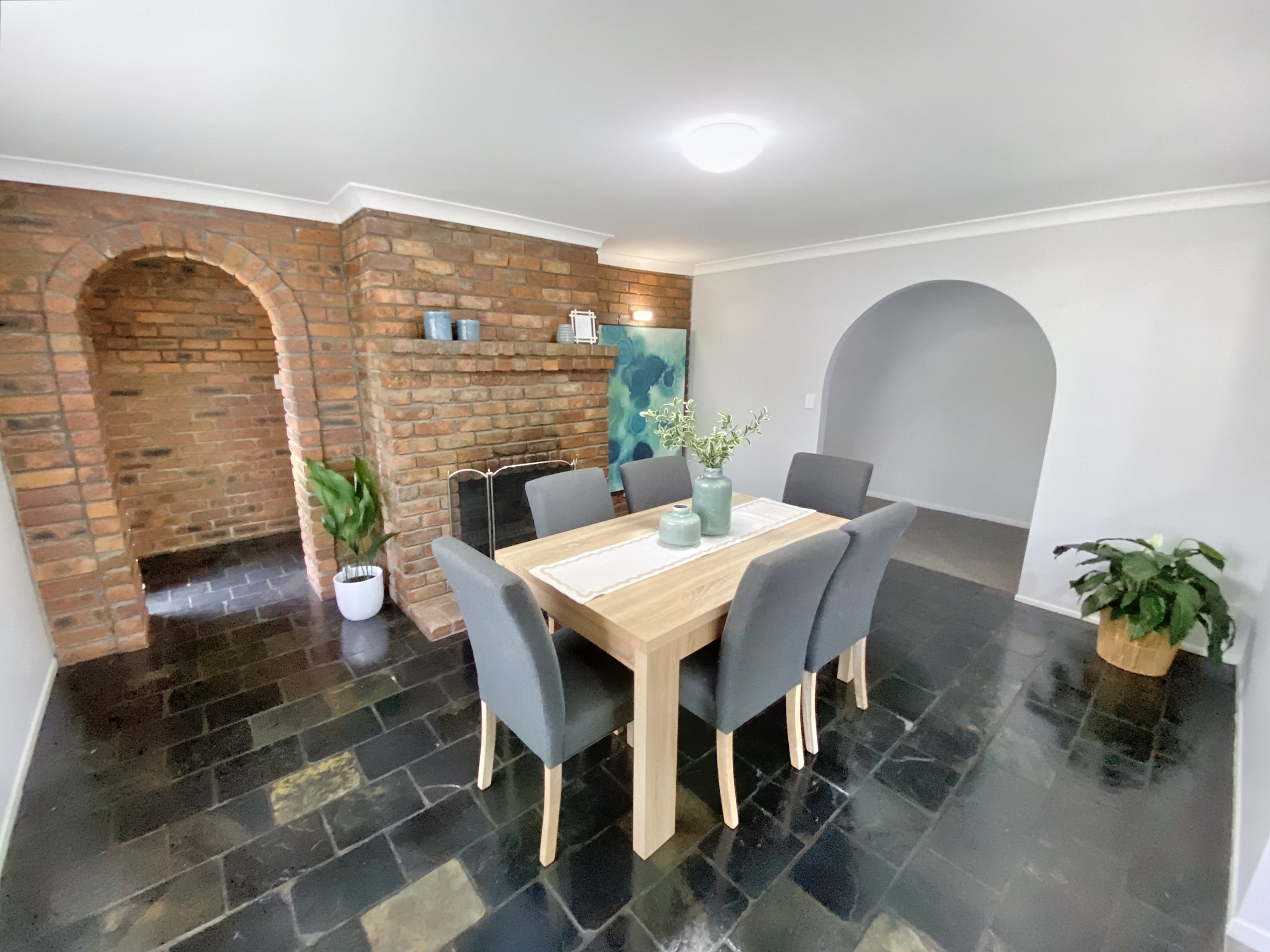 Tiled dining room with a six-seater dining table and chairs. 