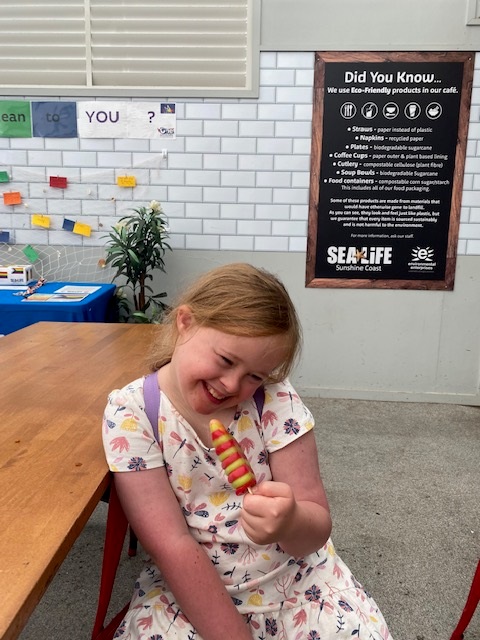 Rosie smiling while enjoying an ice cream
