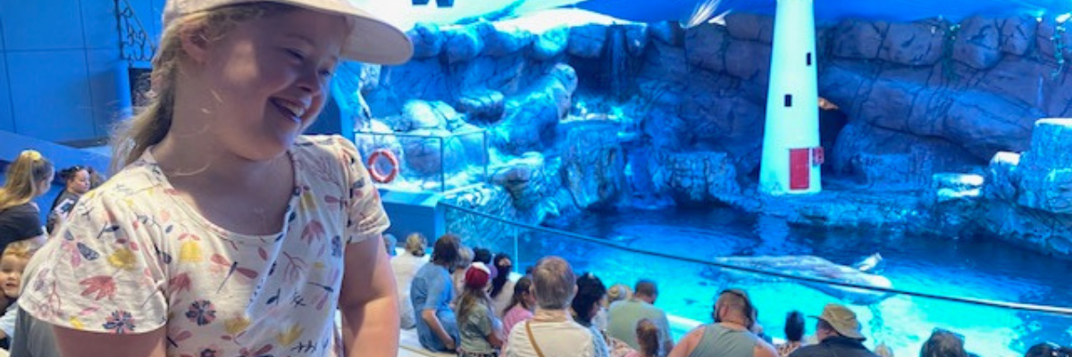 Rosie smiling and watching the Sea Life seal show