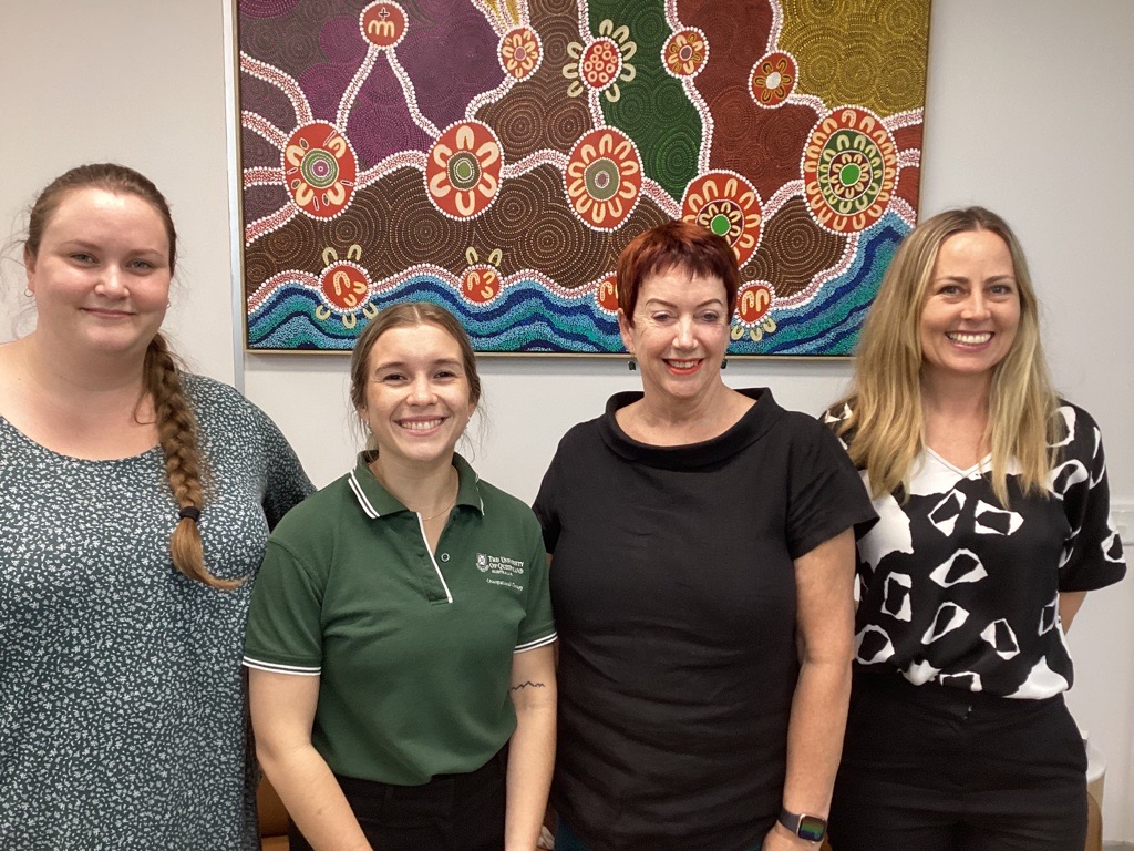 L-R: Heather, Chloe, Jillian and Marissa standing in front of the 'Story of Mamre' indigenous artwork by Uncle Paul Calcott at the Windsor office